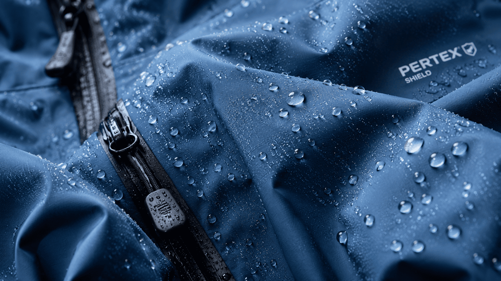 A person wearing a sleek, modern waterproof jacket in the rain