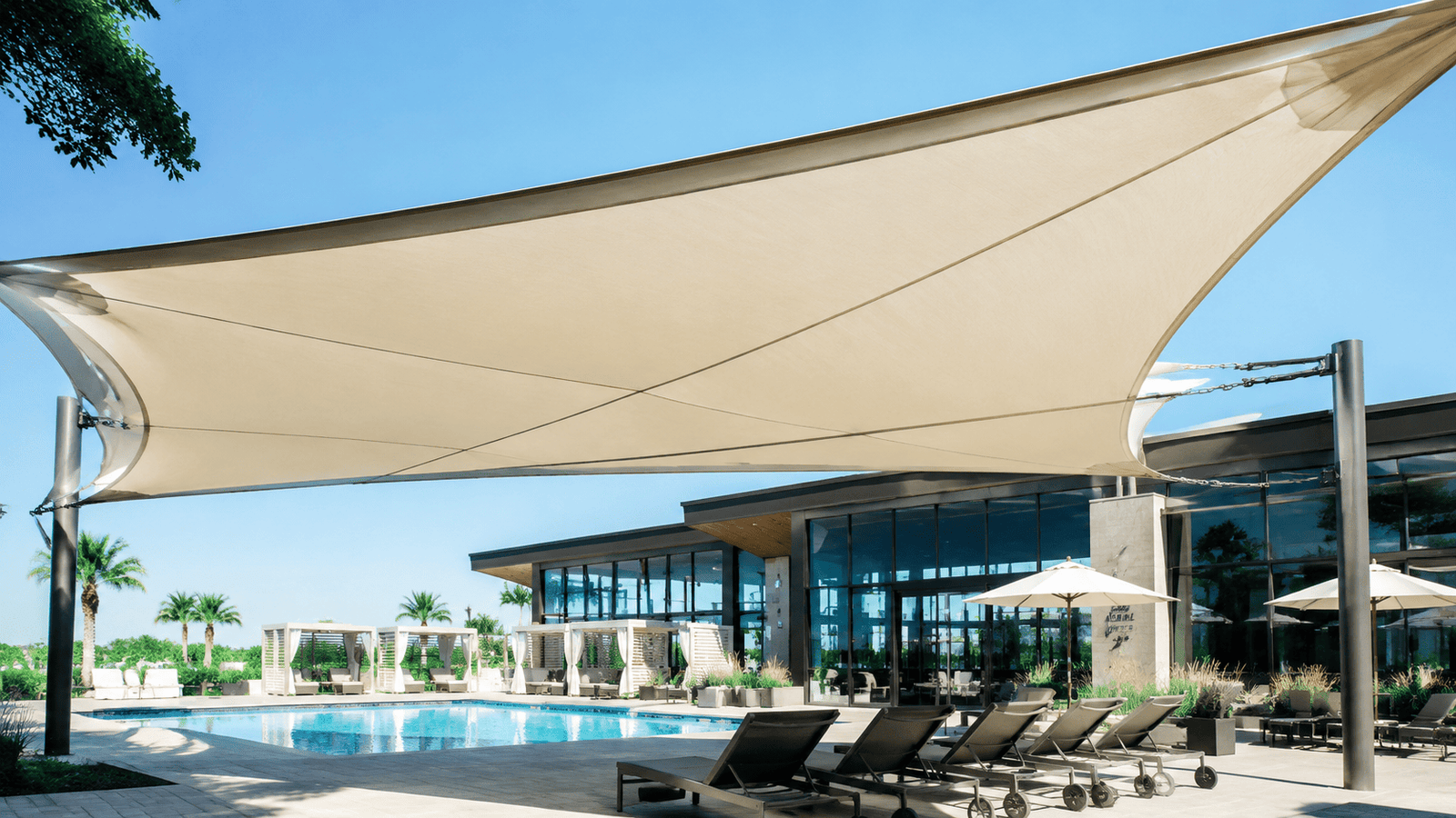 A modern patio with a large sun shelter made from TPU laminated fabric